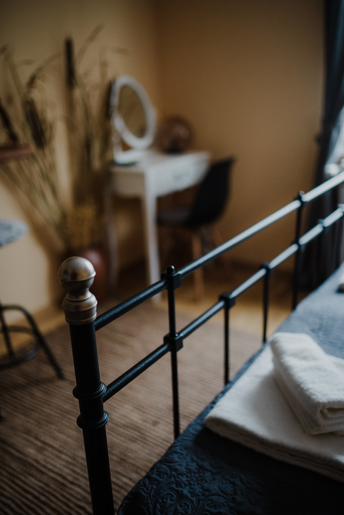 Cozy bedroom interior with a vintage bed and a stylish vanity in soft lighting